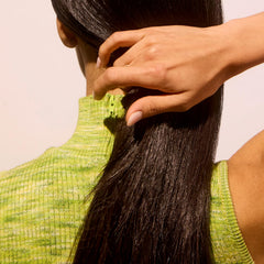 Close-up of Acure Vivacious Volume Shampoo bottle