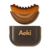 Aeki Brush lymphatic contour face brush for gentle puffiness relief.