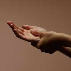Aesop Resurrection Aromatique Hand Balm applied on hands for smooth skin.