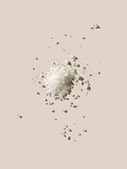 AHAVA Dead Sea bath salt pouring into warm water to ease tension.
