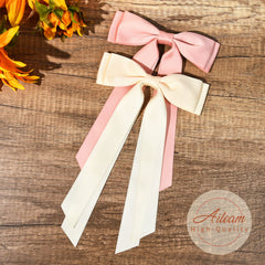Aileam beige-pink satin bow clipped on hair for subtle shine