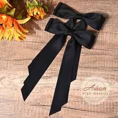 Aileam black satin bow clipped on ponytail showing effortless style.