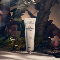 AKT Deodorant Balm application demonstrates a pea-sized dab for odor control.