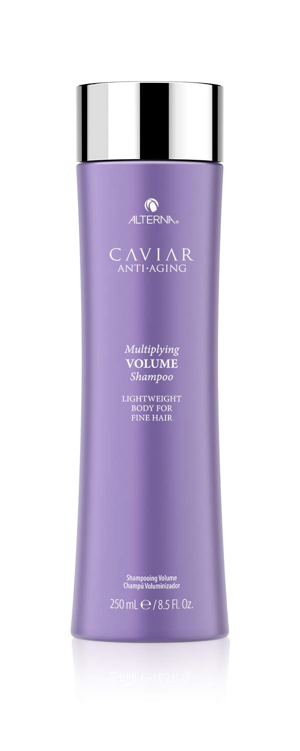 Alterna Caviar Anti-Aging Multiplying Volume Shampoo bottle pours, signaling an instant volume boost.