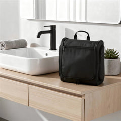 Amazon Essentials waterproof toiletry bag withstands spills and moisture in busy hotel bathrooms.
