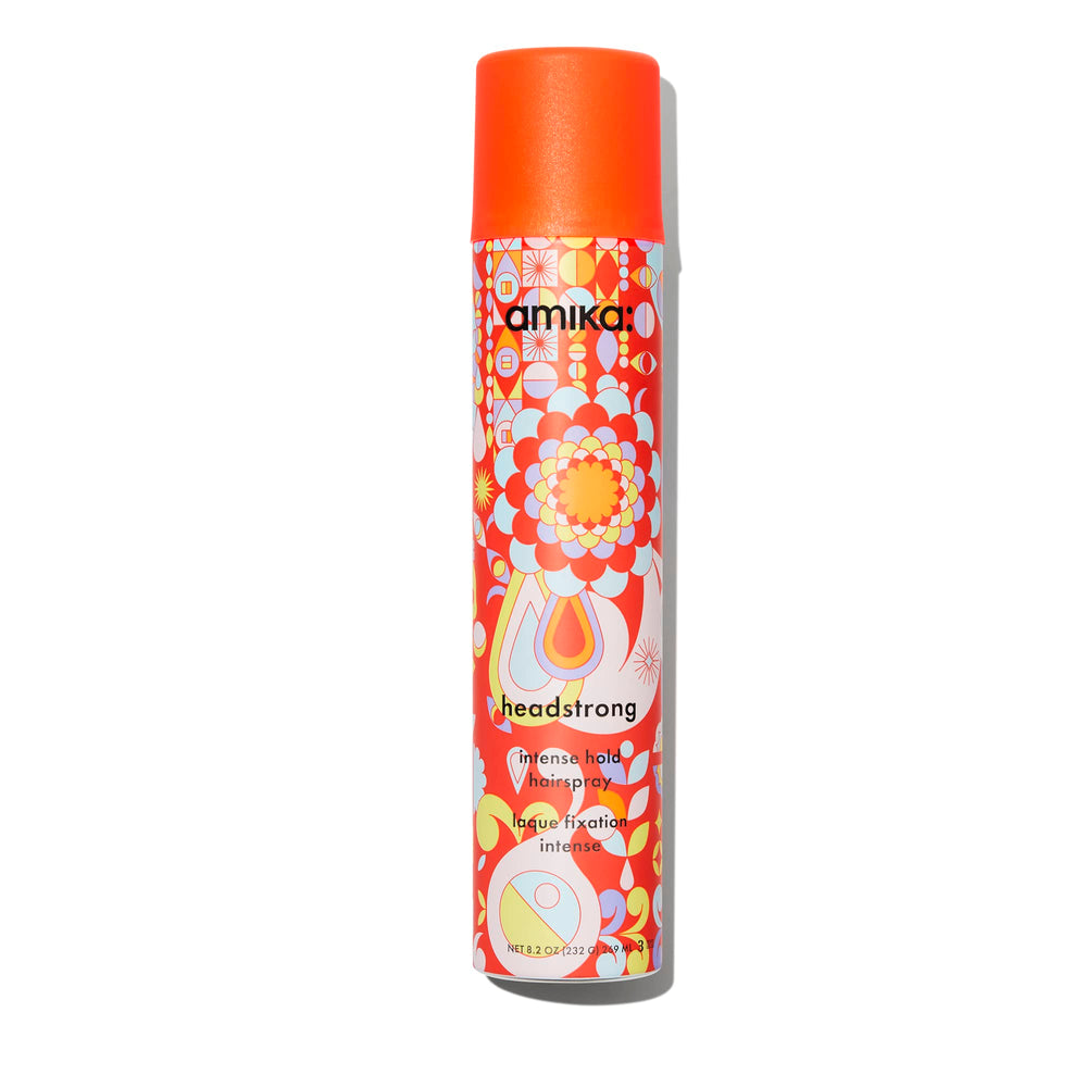 amika Headstrong hairspray bottle delivering fast, powerful hold with a flake-free finish.