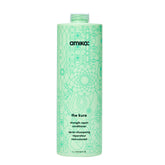 Amika Kure Strength Repair Conditioner bottle pour demonstrates hydration and detangling support
