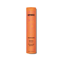Amika Normcore Signature Shampoo bottle pour showing gentle daily cleanse and hydration