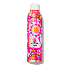 Amika Perk Up Ultra Dry Shampoo bottle on a bathroom counter for oil-control refresh.