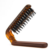 Ancable travel folding hair brush compact for on-the-go detangling and scalp massage.