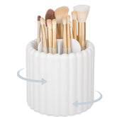 Anyoifax 360 rotating makeup brush holder with 7 slots keeps brushes neatly organized.