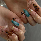 ASABITE almond press-on nails with brown leopard and gold line for chic French tips.