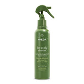 Aveda Be Curly primer bottle showcasing detangling and frizz control for curls.