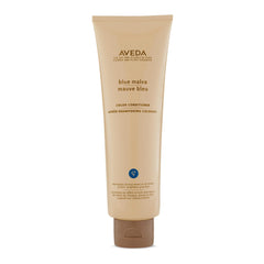 Aveda Blue Malva Color Conditioner bottle shows violet tint that neutralizes brassiness