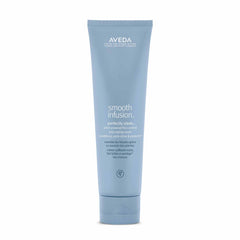 Aveda Smooth Infusion Perfectly Sleek bottle demonstrating frizz defense for textured hair.