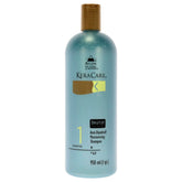 Avlon KeraCare dry scalp shampoo bottle pour shows moisturizing anti-dandruff action.