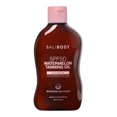 Bali Body Watermelon Tanning Oil SPF50 bottle on a shelf, hydrating protection.