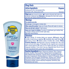Banana Boat Light As Air SPF 50 bottle being rubbed in to clear, fast-absorbing finish.