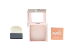 Benefit Cookie Powder Highlighter showcases delicate soft-gold shimmer on skin.