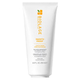 Biolage Smooth Proof Leave-In Cream bottle showing frizz control on damp hair.