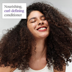 Close-up of Briogeo Curl Charisma on hair demonstrates moisture and curl definition.