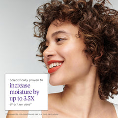 Briogeo Curl Charisma hands applying mask on damp hair for moisture boost.