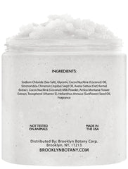 Brooklyn Botany Coconut Milk Body Scrub hand pouring a small amount for even application.