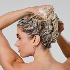 Creamy lather forms while applying Bumble and bumble Hydrating Shampoo for gentle cleansing.
