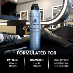 Hands holding Dryspun Texture Spray for styling grip