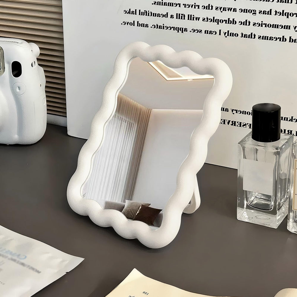 CCREDONE wave-shaped makeup mirror on a desk with a clear, true reflection