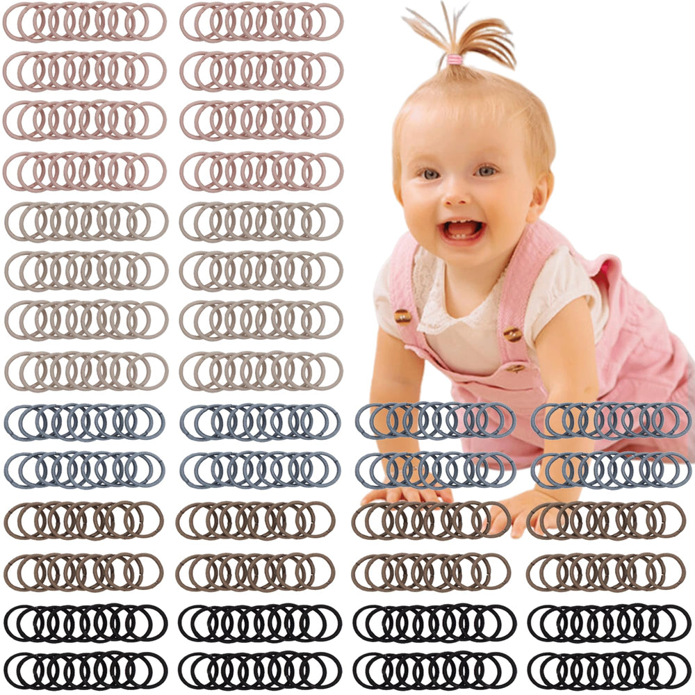 CÉLLOT brown baby hair ties close-up, gentle hold for toddlers.
