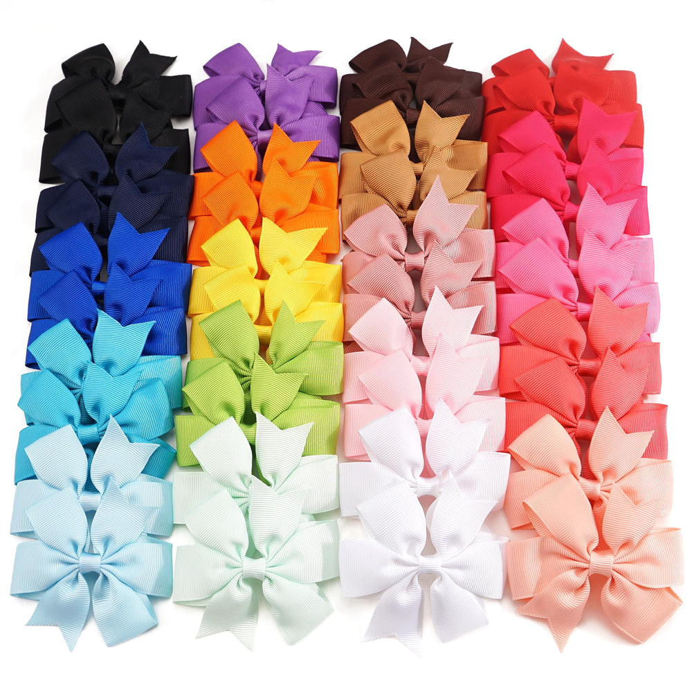 CÉLLOT pink pinwheel bow on a secure alligator clip for playtime styling