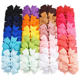 CÉLLOT pink pinwheel bow on a secure alligator clip for playtime styling