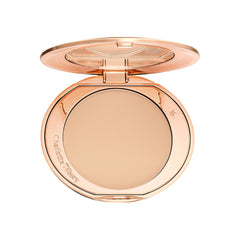 Charlotte Tilbury Airbrush Flawless Finish Powder texture demonstrates pore-blurring smoothness on skin.