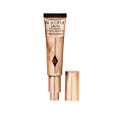 Charlotte Tilbury Beautiful Skin Foundation bottle showing dewy glow for radiant skin.