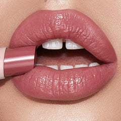 Charlotte Tilbury Hyaluronic Happikiss dewy finish on lips with mirror-like shine.