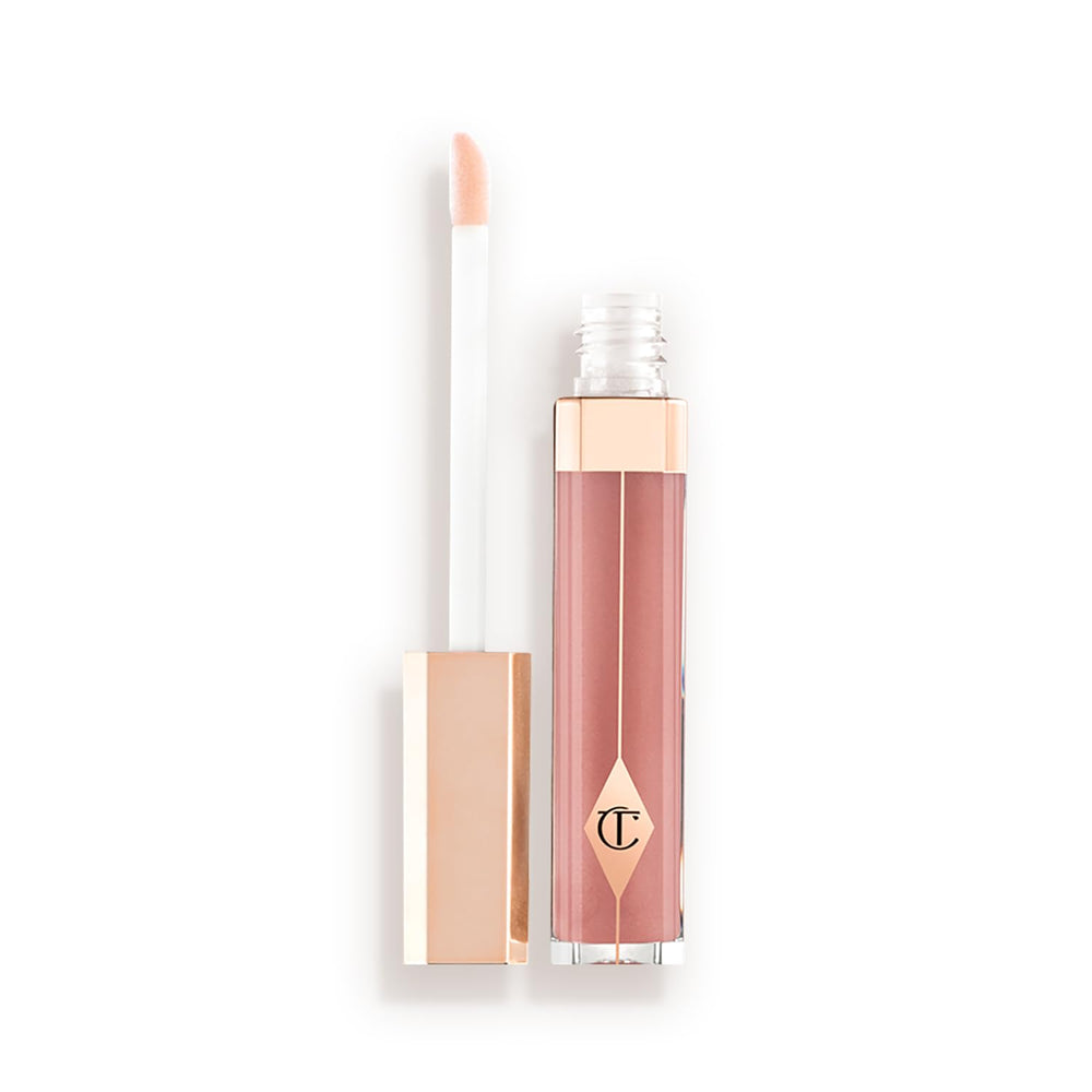 Charlotte Tilbury Lip Lustre high-shine gloss on Pillow Talk lips, cushion-soft and fuller-looking.