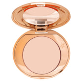 Charlotte Tilbury Magic Vanish Color Corrector in Fair bottle brightening under-eye area.