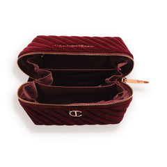 Interior of the Charlotte Tilbury bag showing three compartments and a zip pocket for organization.