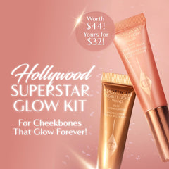 Charlotte Tilbury Spotlight wand highlights cheekbones with dewy shine.