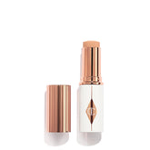 Charlotte Tilbury Unreal Skin Tint bottle close-up shows a glow-ready finish