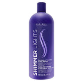 Clairol Profesional Purpura – botella que neutraliza tonos amarillos en rubios.