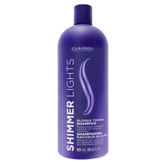 Clairol Profesional Purpura – botella que neutraliza tonos amarillos en rubios.