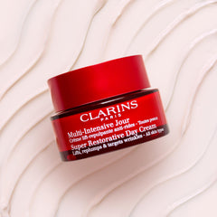 Clarins Super Restorative Day Cream pump closeup illustrates clean, convenient dispensing.
