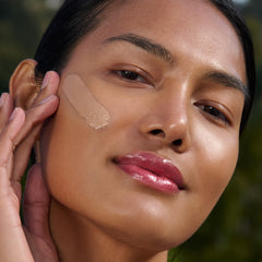 Clarins UV Plus bottle close-up highlights lightweight texture for all-day comfort.
