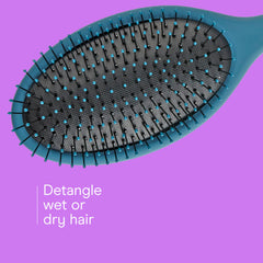 Conair Detangling Hair Brush Set in coral eases knots during styling.
