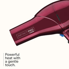 Conair Infiniti Pro blowout brush in use for a smooth, voluminous finish.