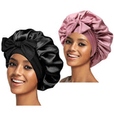 Confvrter silk bonnet pair in pink and black protects hair gently while sleeping.