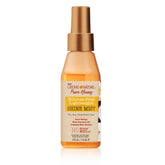 Creme of Nature Pure Honey Shine Mist bottle demonstrates silicone-free hydration for frizz control