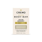 Cremo Exfoliating Body Bar with Italian Bergamot lather and lava rock for gentle buffing.